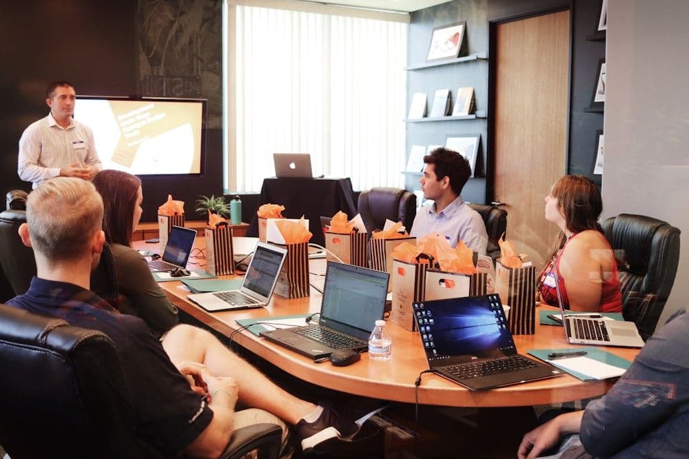 A campaign kickoff meeting with the account team around a boardroom table