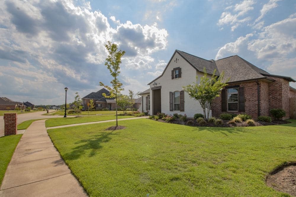 A brick family home on a landscaped lot in a new development